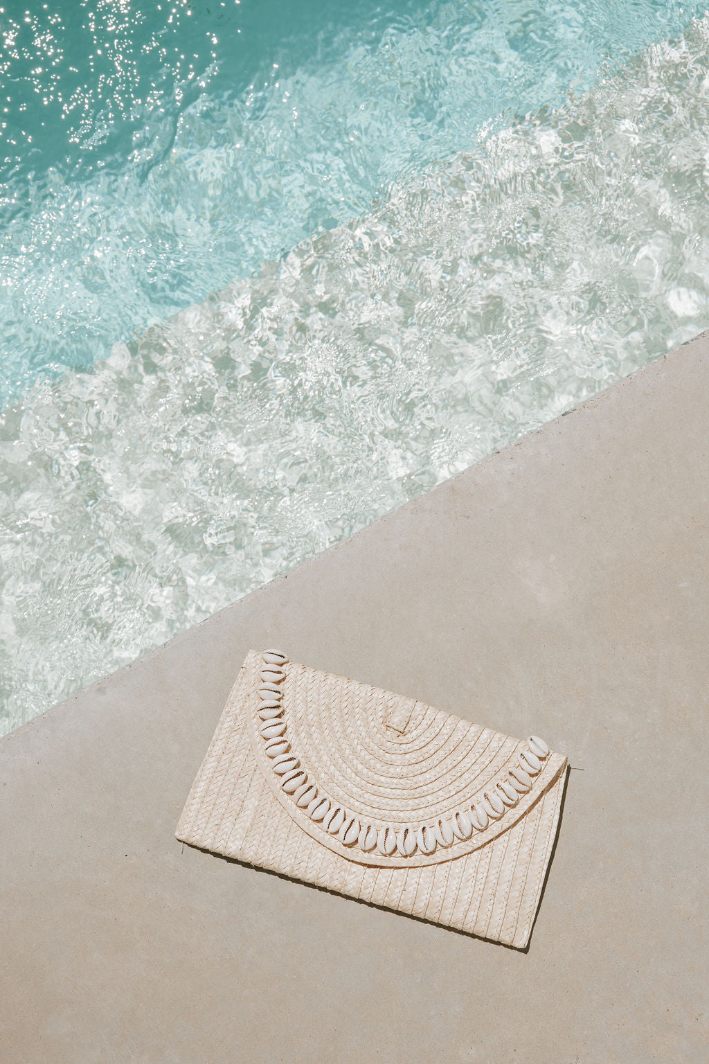 Sandi Cowrie Clutch