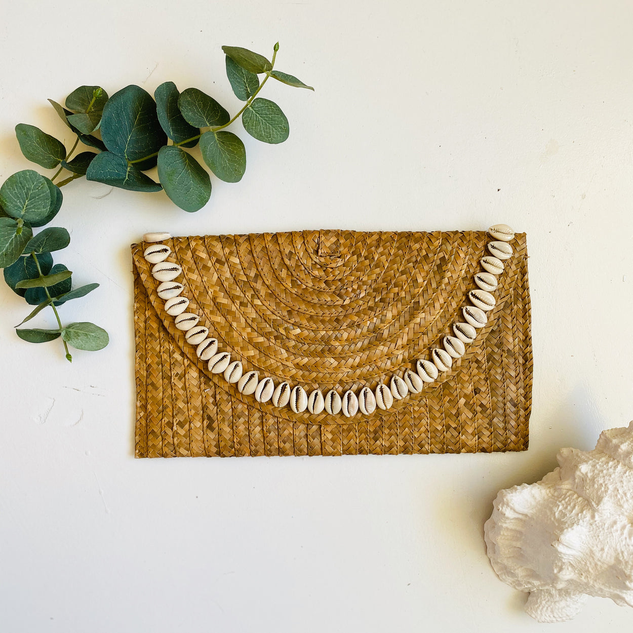 Sandi Cowrie Clutch