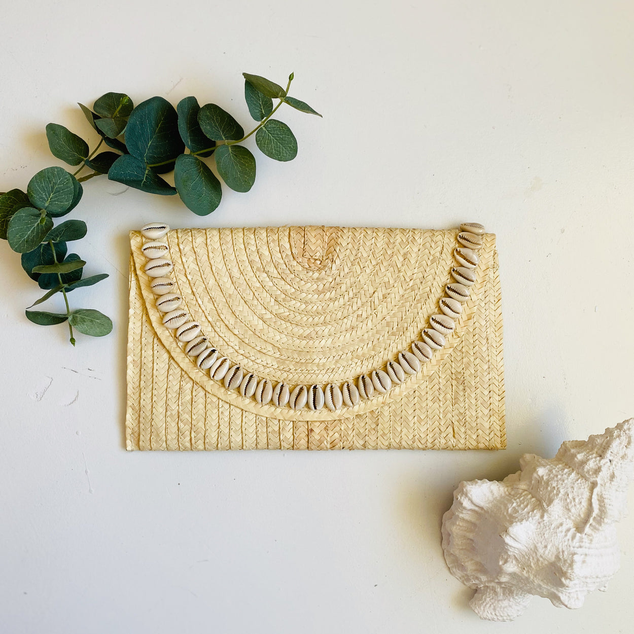 Sandi Cowrie Clutch