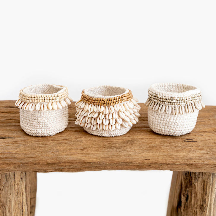 Handmade macramé storage basket with natural shell trim, woven cotton boho basket for coastal home décor and stylish storage.